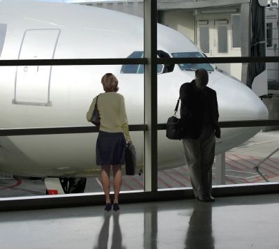 Man and Woman Waiting For Airplane